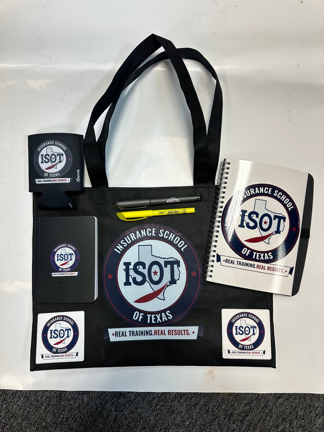 The ISOT student kit: tote bag, spiral notebook, journal, pen, highlighter, koozie and stickers